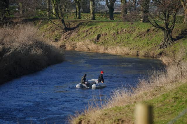Specialist search officers drive a boat along the River Wyre where Lancashire Police are searching (Photo: PA)