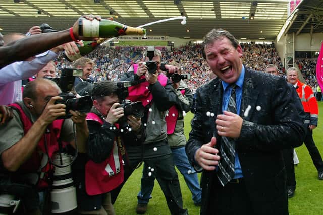 Kevin Campbell pours champagne over manager Bryan Robson  after securing premiership status. (Getty Images)