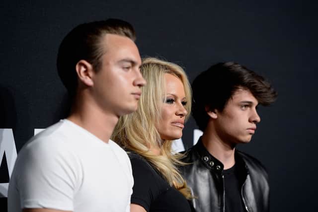 Pamela Anderson (center) and her sons Brandon Lee (L) and Dylan Lee attend the Saint Laurent show at The Hollywood Palladium in 2016 (Photo: Getty Images)