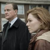 Emun Elliot as Tony Brightwell, Hugh Bonneville as Brian Boyce, and Charlotte Cooper as Nikki Jennings in The Gold (Credit: BBC/Tannadice Pictures/Sally Mais)