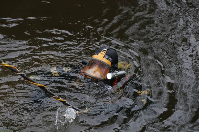 A diver searches in the River Wyre, in St Michael's on Wyre, Lancashire