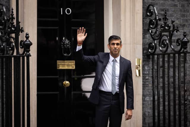 British Prime Minister Rishi Sunak waves to members of the media after taking office outside Number 10 in Downing Street on October 25, 2022 in London, England. Credit: Getty Images