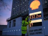 Activists from Greenpeace set up a mock-petrol station price board displaying the Shell's net profit for 2022 (Getty)