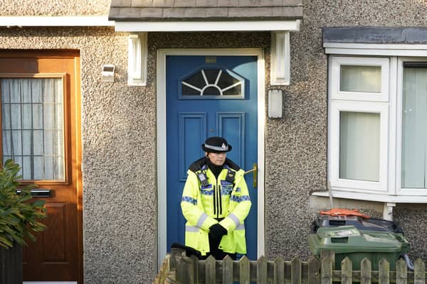 A police officer stands outside a property in Walpole Road, Huddersfield, West Yorkshire, where a woman was arrested on suspicion of attempted murder, after four people, including three children, were found seriously injured. Credit: PA