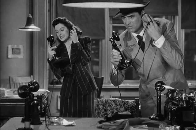 Cary Grant as Walter Burns and Rosalind Russell as Hildy Johnson in His Girl Friday, answering the phones (Credit: Colombia Pictures)