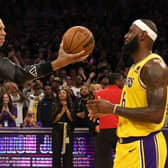 Abdul-Jabbar hands the ball to James after the Lakers star broke Abdul-Jabbar’s record