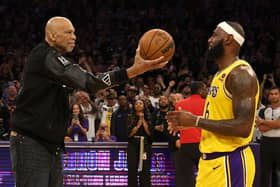Abdul-Jabbar hands the ball to James after the Lakers star broke Abdul-Jabbar’s record
