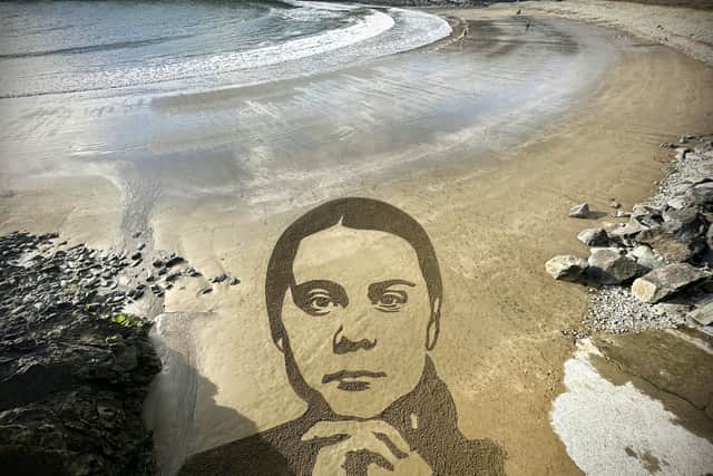 Artist Sean Corcoran has created a 100ft sketch of Greta Thunberg on a beach using two rakes. 