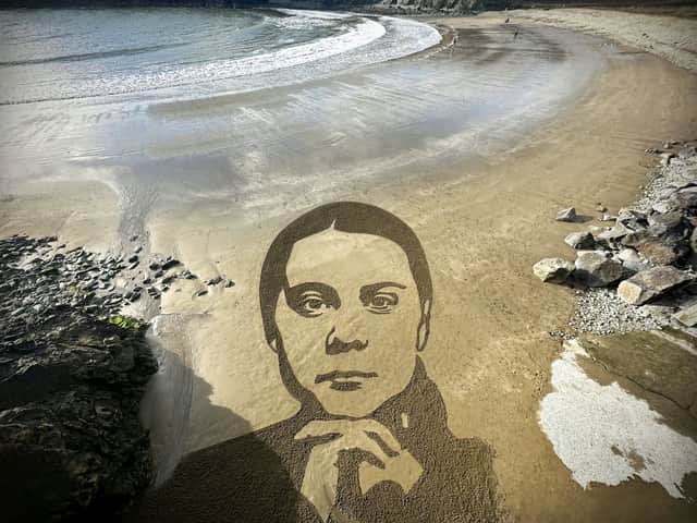 Artist Sean Corcoran has created a 100ft sketch of Greta Thunberg on a beach using two rakes. 