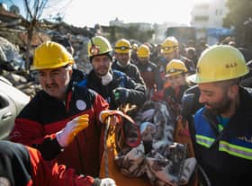 Rescue workers carry a survivor at the site of a collapsed building after 60 hours on from the earthquake on on February 08, 2023 in Hatay, Turkey. Credit: Burak Kara/Getty Images