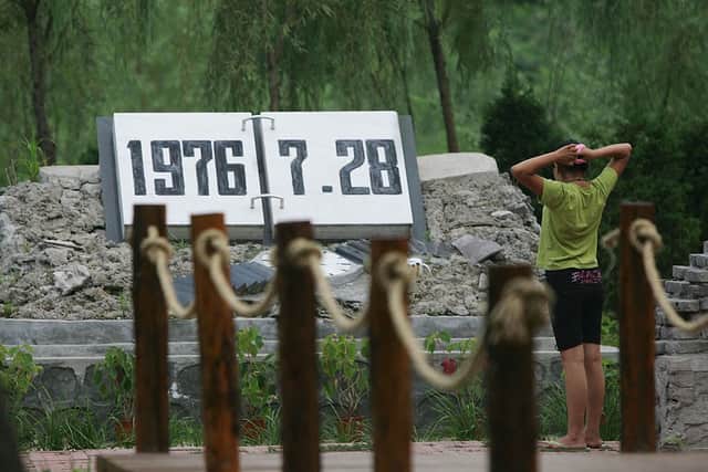 People mark the 30th anniversary of the Tangshan earthquake in 2006. Credit: China Photos/Getty Images