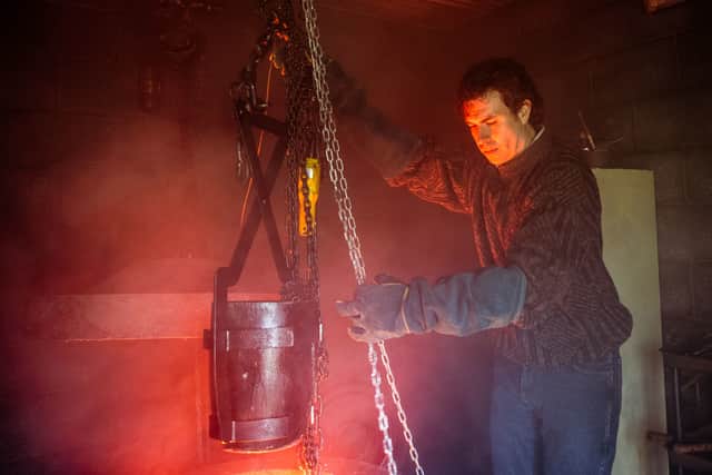 Tom Cullen as John Palmer in The Gold, smelting bullion to disguise the stolen gold (Credit: BBC/Tannadice Pictures/Sally Mais)