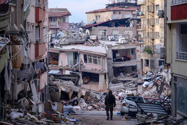 A Turkish soldier walks among destroyed buildings in Hatay, on February 12, 2023. (Getty Images)