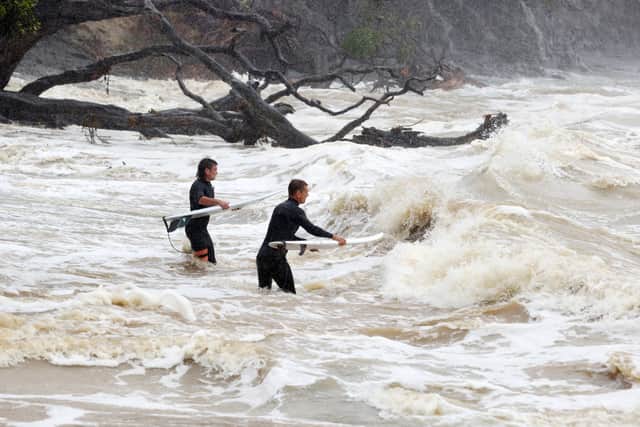 Surfers brave large waves and rough seas caused by Cyclone Gabrielle at Goat Island Marine Reserve in Auckland, New Zealand (Photo by Fiona Goodall/Getty Images). 