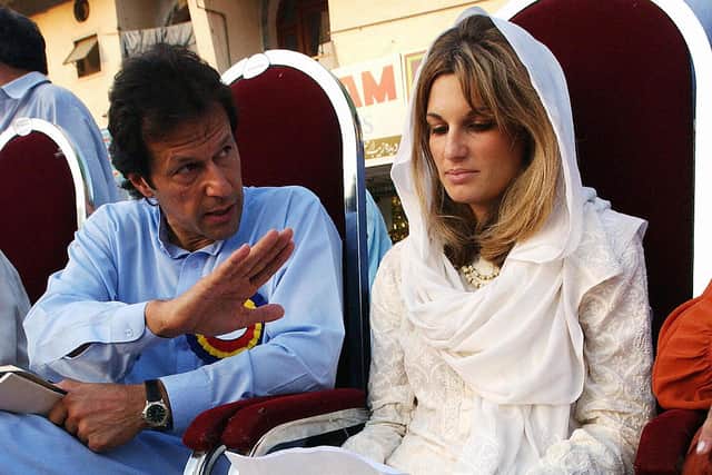 In this picture taken 16 September 2002, Jemima Khan (R) wife of Pakistan's cricket legend turned politician Imran Khan, reads her prepared statement in local Urdu language as Khan looks on during a public rally to boost her husband's election campaign in Islamabad. AFP PHOTO/ Saeed KHAN (Photo credit: SAEED KHAN/AFP via Getty Images)