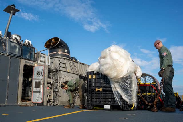 In this U.S. Navy handout, Sailors assigned to Assault Craft Unit 4 prepare material recovered in the Atlantic Ocean from a high-altitude balloon for transport to federal agents at Joint Expeditionary Base Little Creek 10 February 2023