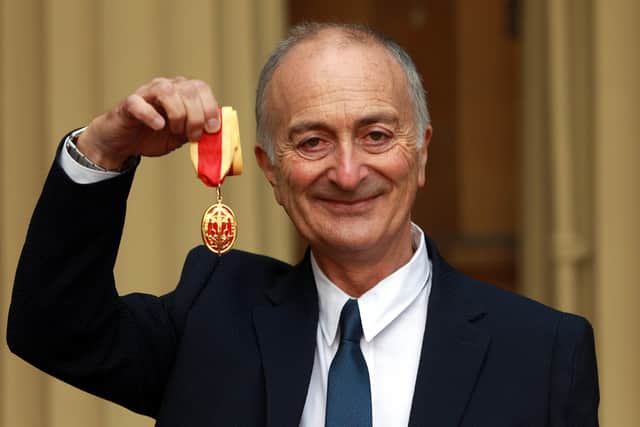 Sir Tony Robinson holds his medal after being knighted by the Duke of Cambridge during an investiture ceremony at Buckingham Palace on November 12, 2013 in London, England. (Photo by Sean Dempsey - WPA Pool/Getty Images)