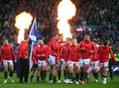 The Wales team take to the field as the fire flares go off during the Six Nations Rugby match between Scotland. (Getty Images)