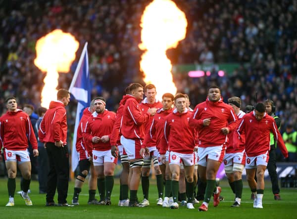 The Wales team take to the field as the fire flares go off during the Six Nations Rugby match between Scotland. (Getty Images)
