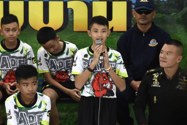 Duangphet Promthep (C), one of the twelve boys dramatically rescued from deep inside a Thai cave after being trapped for more than a fortnight, speaks during a press conference in Chiang Rai on July 18, 2018, following their discharge from the hospital (Photo: LILLIAN SUWANRUMPHA/AFP via Getty Images)