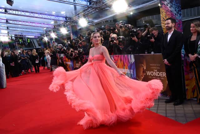 Florence Pugh twirled around in a coral Valentino gown to the UK Netflix premiere of the film The Wonder.  (Photo by Gareth Cattermole/Getty Images for BFI)