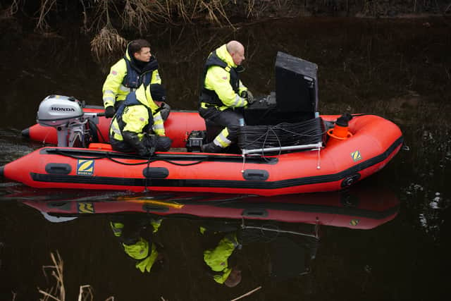 Peter Faulding (right) and his team search the river (Photo: PA)