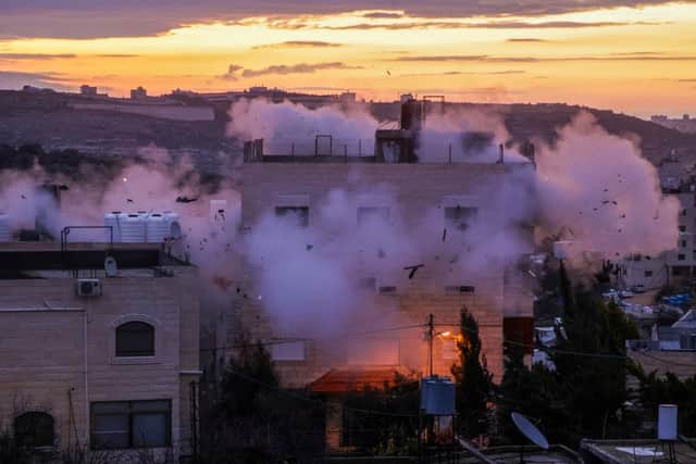 Smoke billows as the residence of Mohammad al-Jaabari, a Palestinian who carried out a shooting attack last year, is demolished by Israeli forces (Photo by HAZEM BADER/AFP via Getty Images).