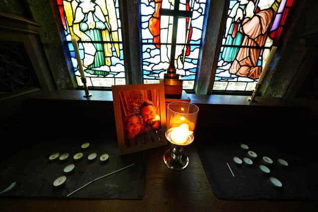 A candle is lit in front of a photo of Nicola Bulley and her partner Paul Ansell on an altar at St Michael’s Church in St Michael’s on Wyre (Photo: PA)