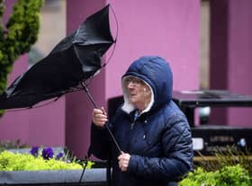 A pedestrian struggles with her umbrella against the wind in Glasgow city centre on August 25, 2020, as Storm Francis brings rain and high winds to the UK. (Photo by ANDY BUCHANAN/AFP via Getty Images)