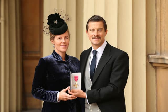 Bear Grylls poses with his wife Shara as he holds his OBE following an investiture ceremony at Buckingham Palace, on October 10, 2019 in London, England. (Photo by Jonathan Brady - WPA Pool/Getty Images)