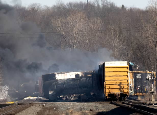 A train derailed in East Palestine, Ohio, with a controlled explosion of hazardous chemicals taking place. (Credit: Getty Images)