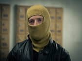 Adam Nagaitis as Brink’s Mat robber Micky McAvoy in The Gold, wearing a balaclava (Credit: BBC/Tannadice Pictures/Sally Mais)