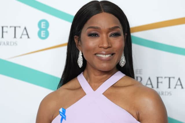 Angela Bassett pins a blue ribbon to her dress at the BAFTAs (Pic:Getty)