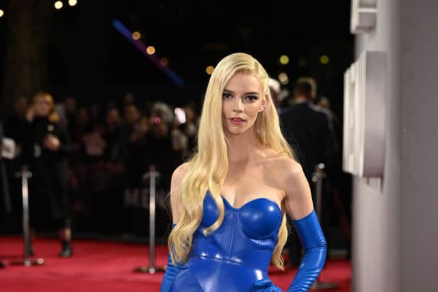 Anya Taylor-Joy wore blue opera style gloves to the premiere of The Menu. Photo by Jeff Spicer/Getty Images for Disney)