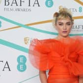 Florence Pugh wowed in a bright orange dress at the Baftas 2023. Photographs by Getty