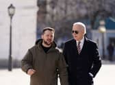 US President Joe Biden (R) walks next to Ukrainian President Volodymyr Zelensky (L) as he arrives for a visit in Kyiv. Credit: DIMITAR DILKOFF/AFP via Getty Images)