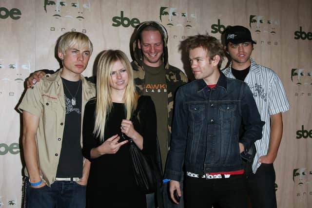 Singers Avril Lavigne (left) and Deryck Whibley (right) arrive at the AREA Nightclub Grand Opening on September 28, 2006 in Los Angeles, California.  (Photo by Michael Buckner/Getty Images)