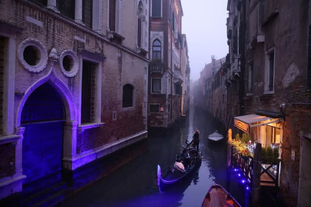 A gondola makes its way along a narrow canal during normal water levels (Photo: Getty Images)