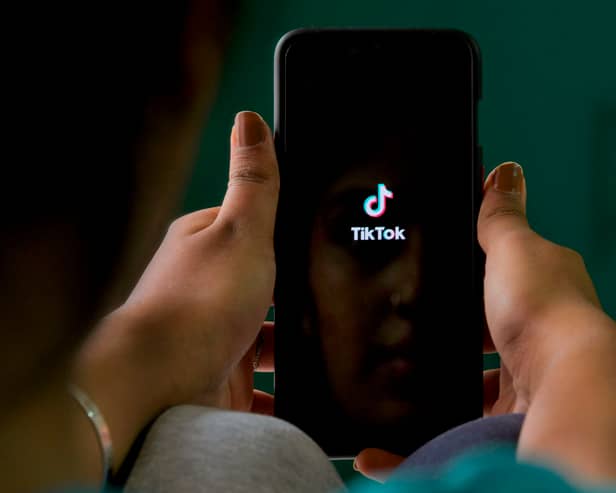 A mobile user browses through the Chinese owned video-sharing TikTok app on a smartphone (Photo: MANJUNATH KIRAN/AFP via Getty Images)