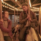 Bella Ramsey as Ellie Williams & Storm Reid as Riley Abel in The Last of Us, on a roundabout carousel (Credit: HBO)