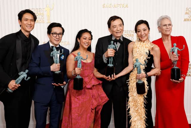 (L-R) Harry Shum Jr., Ke Huy Quan, Stephanie Hsu, James Hong, Michelle Yeoh, and Jamie Lee Curtis, recipients of the Outstanding Performance by a Cast in a Motion Picture award for “Everything Everywhere All at Once,” pose in the press room during the 29th Annual Screen Actors Guild Awards at Fairmont Century Plaza on February 26, 2023 in Los Angeles, California. (Photo by Frazer Harrison/Getty Images)