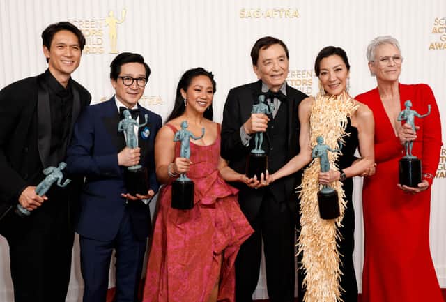 (L-R) Harry Shum Jr., Ke Huy Quan, Stephanie Hsu, James Hong, Michelle Yeoh, and Jamie Lee Curtis, recipients of the Outstanding Performance by a Cast in a Motion Picture award for “Everything Everywhere All at Once,” pose in the press room during the 29th Annual Screen Actors Guild Awards at Fairmont Century Plaza on February 26, 2023 in Los Angeles, California. (Photo by Frazer Harrison/Getty Images)
