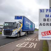 A lorry passes an anti ‘Northern Ireland Protocol’ sign as it is driven away from Larne port, north of Belfast in Northern Ireland (Photo: AFP via Getty Images)