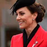 Kate Middleton dazzled in a leek brooch and red Alexander McQueen coat for St David's Day. Photo by ALASTAIR GRANT/POOL/AFP via Getty Images)

