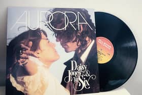 The album Aurora by Daisy Jones & The Six, a vinyl record falling out of the album sleeve (Credit: Amazon Prime Video)