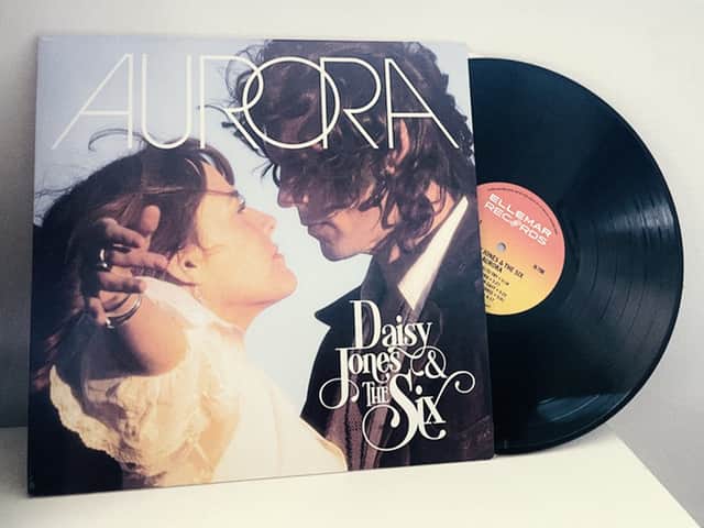 The album Aurora by Daisy Jones & The Six, a vinyl record falling out of the album sleeve (Credit: Amazon Prime Video)