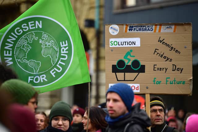 Striking public transport workers and activists from Fridays for Future walk with flags during the 3 March protest in Hanover, Germany (Photo by Alexander Koerner/Getty Images)