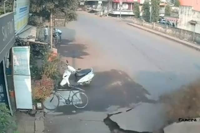 Harrowing moment road explodes in India. Picture: SWNS