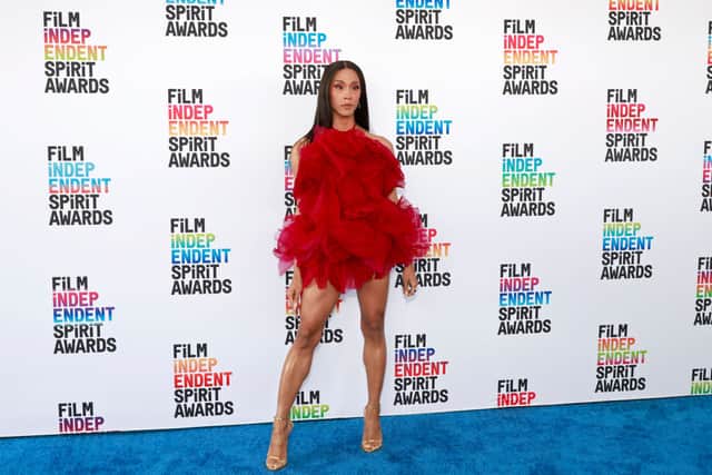 Michaela Jaé Rodriguez looked incredible in a mini ruffled burgundy dress. Photo by Getty