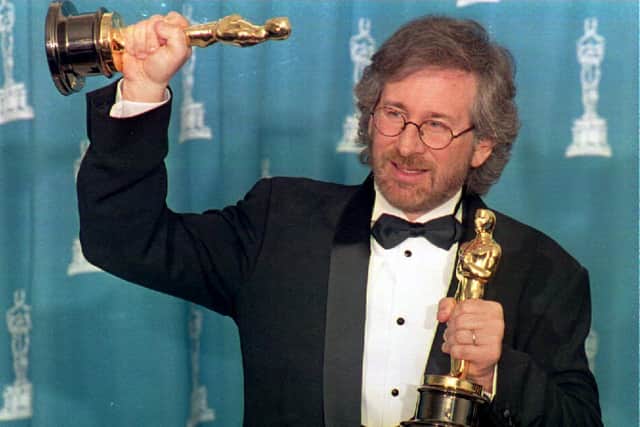 US director Steven Spielberg poses with his two Oscars 21 March 1994 in Los Angeles, CA during the 66th Annual Academy Awards ceremony after winning the 1993 wards for best director and best picture for his movie “Schindler’s List.” (Credit: DAN GROSHONG/AFP via Getty Images)